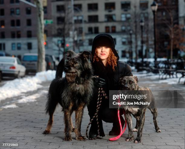 Bernadette Peters stands with her dogs during the winter of 1995 on the street in New York City. Peters, an award winning singer and actress has...