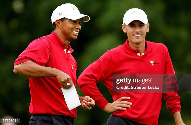 Tiger Woods and teammate Charles Howell III of the U.S. Team smile during the round one foursome matches at The Presidents Cup at The Royal Montreal...