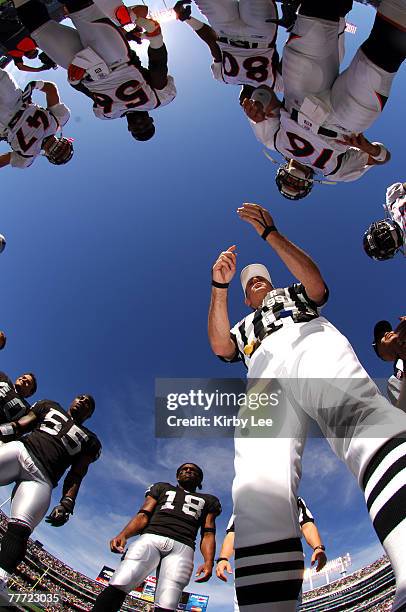 Referee Tony Corrente conducts coin toss before game between the Denver Broncos and Oakland Raiders at McAfee Coliseum in Oakland, Calif. On Sunday,...