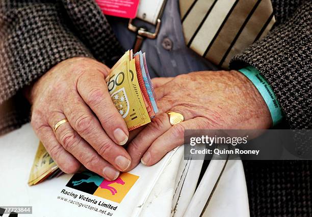 Bookie holds money at The Melbourne Cup Carnival meeting at Flemington Racecourse November 6, 2007 in Melbourne, Australia.