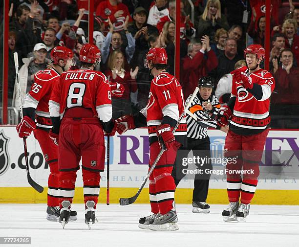 Eric Staal of the Carolina Hurricanes is congratulated by teammates Justin Williams and Matt Cullen after his goal against the Washington Capitals on...