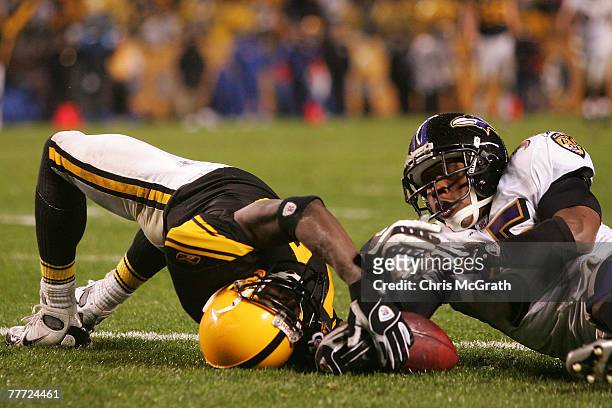 Santonio Holmes of the Pittsburgh Steelers is tackled by Corey Ivy of the Baltimore Ravens in the endzone, the catch and touchdown was disallowed on...