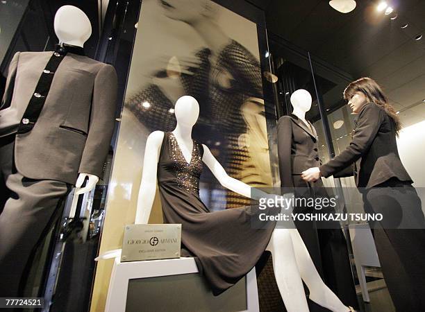 Sales clerk prepares for the opening of Italian designer Giorgio Armani's new flagship shop "Armani Ginza Tower" at a press preview in central Tokyo...