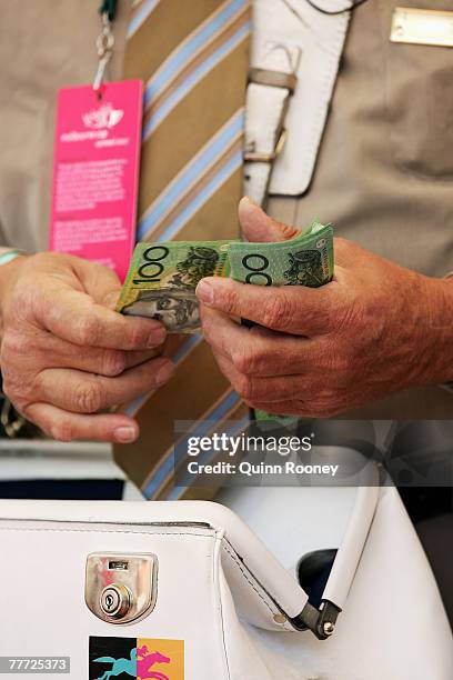 Bookie counts money at The Melbourne Cup Carnival meeting at Flemington Racecourse November 6, 2007 in Melbourne, Australia.