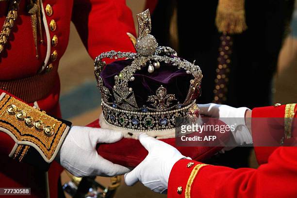 The crown to be worn by Queen Elizabeth II arrives at the Soverign Entrance of the House of Lords, in Westminster, in London, 06 November 2007, for...