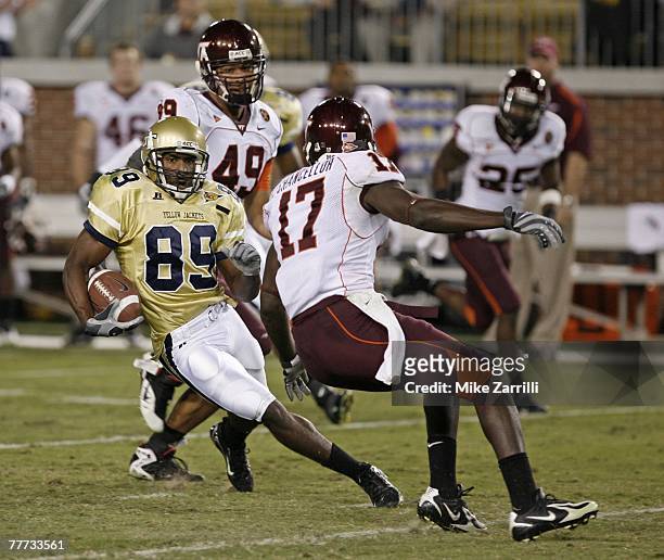 Wide receiver James Johnson of the Georgia Tech Yellow Jackets makes a reception and tries to elude defender Kam Chancellor of the Virginia Tech...