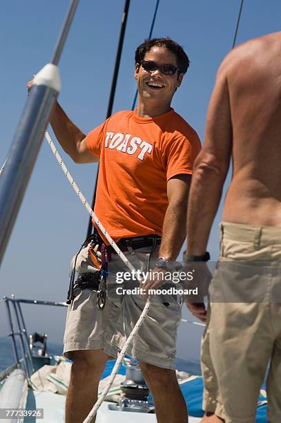 sailors working ropes during yacht race - yachting race stock pictures, royalty-free photos & images