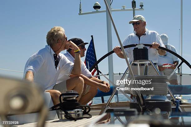 crew at the helm during yacht race - yachting race stock pictures, royalty-free photos & images