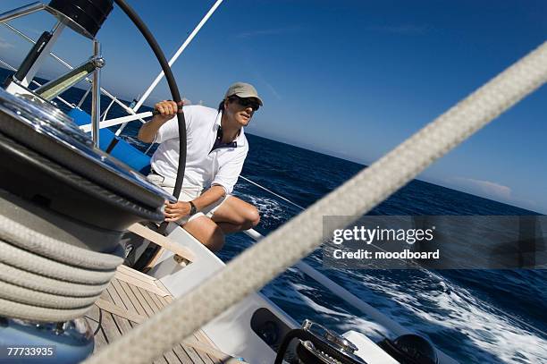 sailor at the helm during sailing yacht race - yachting race stock pictures, royalty-free photos & images