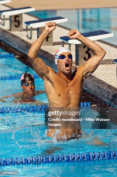 winning swimmer - swimming competition stock pictures, royalty-free photos & images