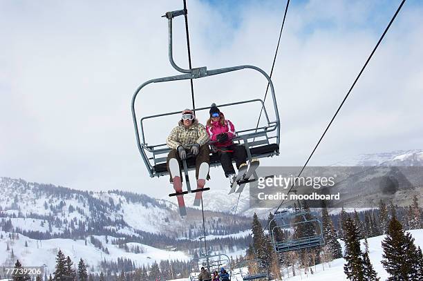 young couple on the chair lift - couple ski lift stockfoto's en -beelden