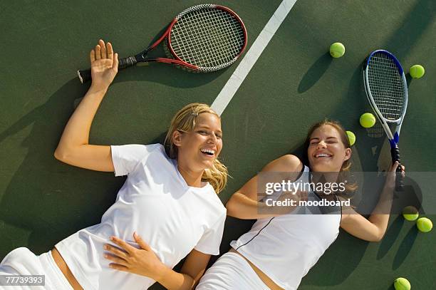 women fatigued and laughing after tennis match - doubles sports stock pictures, royalty-free photos & images