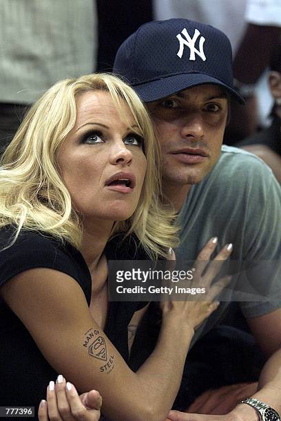 Pamela Anderson and model Marcus Schenkenberg watch Game 2 of the NBA Finals between the Los Angeles Lakers and the Indiana Pacers, June 9, 2000 in...