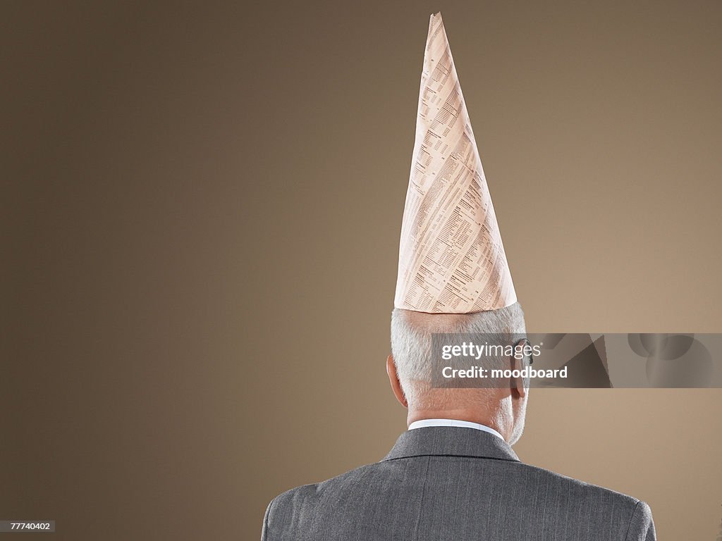 Businessman Wearing Dunce Cap