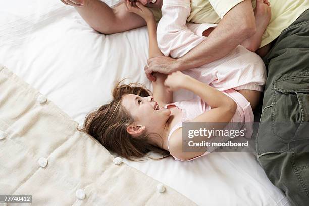 playful young girl - kietelen stockfoto's en -beelden