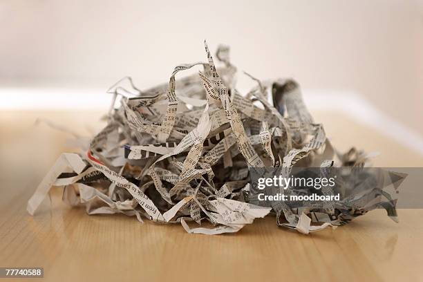 pile of shredded newspaper - shredded newspaper stock pictures, royalty-free photos & images