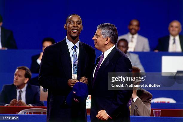 Kenny Anderson shakes hands with NBA Commissioner David Stern after he was selected number two overall by the New Jersey Nets during the 1991 NBA...