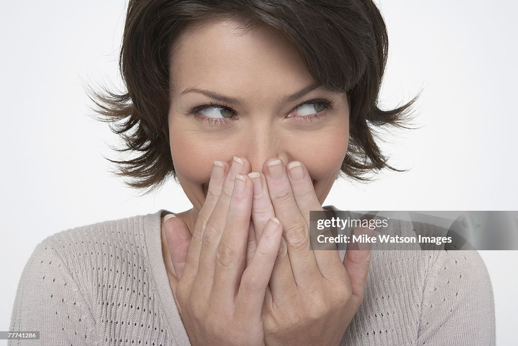 Woman Covering Mouth with Hands
