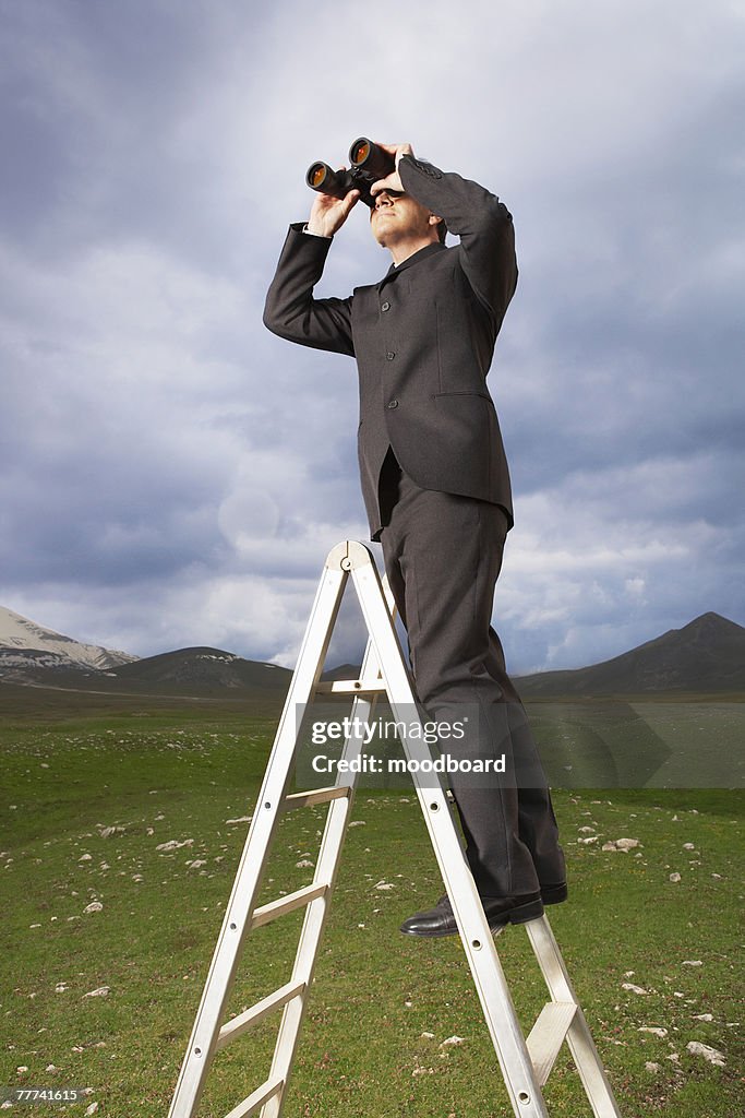 Businessman Looking Through Binoculars