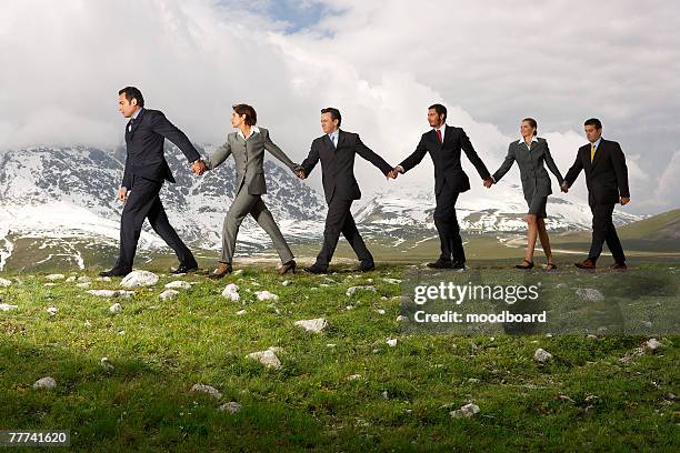 business people holding hands and walking - man and woman holding hands profile stock-fotos und bilder