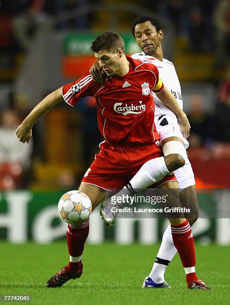 Edouard Cisse of Besiktas tangles with Steven Gerrard of Liverpool during the UEFA Champions League Group A match between Liverpool and Besiktas at...