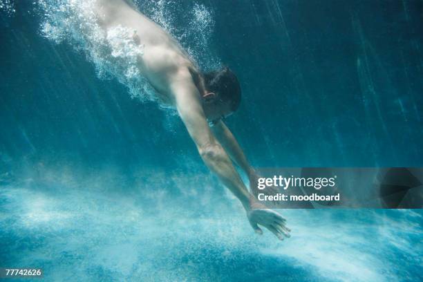 man diving into pool - man diving in pool stock pictures, royalty-free photos & images
