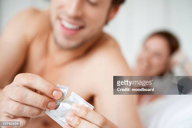 couple practicing safe sex - condom stock pictures, royalty-free photos & images