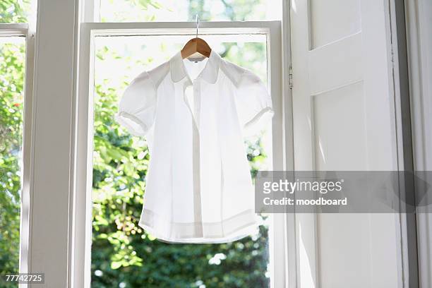blouse on hanger - camisa blanca fotografías e imágenes de stock