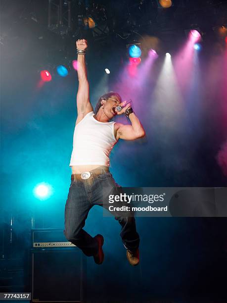 young man singing at concert - pop music stock-fotos und bilder