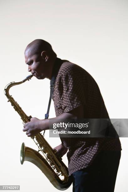 man playing saxophone - saxophoniste photos et images de collection