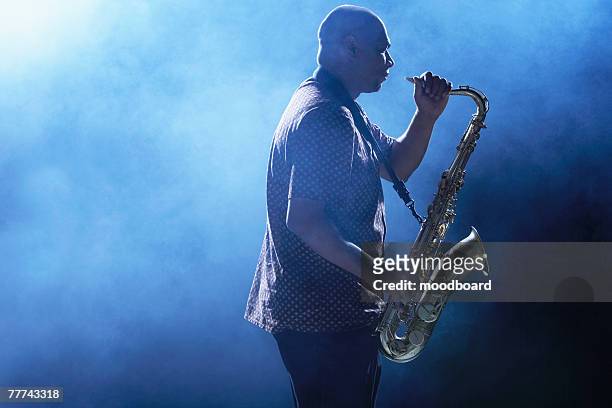 man playing saxophone - blues musicians stock pictures, royalty-free photos & images