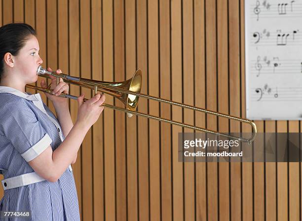 high school student practicing trombone - trombone stock pictures, royalty-free photos & images
