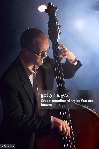 man playing double bass in jazz club - double bass stock pictures, royalty-free photos & images