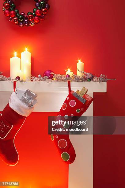 christmas stockings hanging from the fireplace - mantelpiece stock pictures, royalty-free photos & images