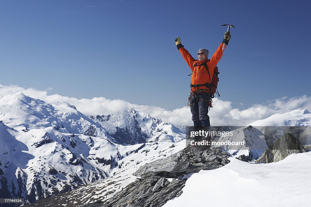 Excited Mountaineer Standing on Apex