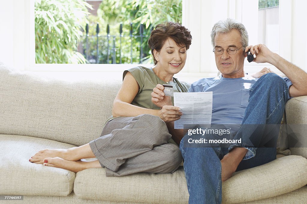 Couple Paying Bill Over Phone