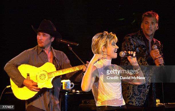 Left to right, Clint Black, Olivia Newton-John and Kenny Loggins perform June 1, 2000 at the Jubilation 2000 Concert at the home of producer Alan...