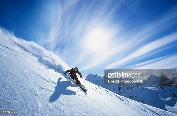 skier carving a turn in fresh powder - ski jumper stock pictures, royalty-free photos & images