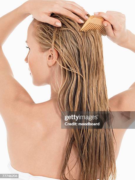 young blond woman combing hair - blonde hair rear white background stock pictures, royalty-free photos & images