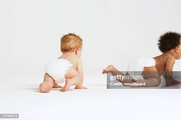 babies crawling away - krabbeln stock-fotos und bilder
