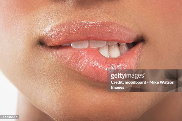 woman biting lip - menselijke lippen stockfoto's en -beelden