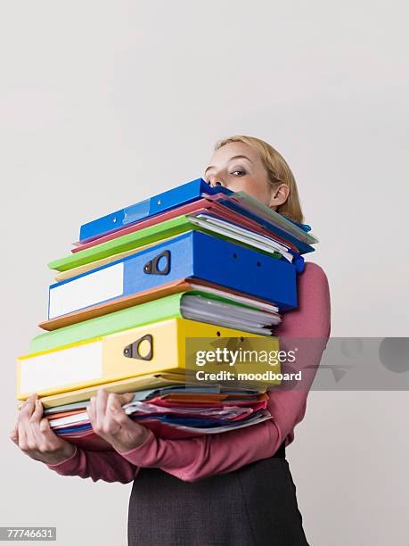 businesswoman carrying too many binders - man made object stock pictures, royalty-free photos & images