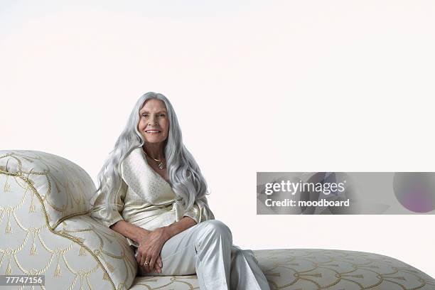 senior woman on chaise lounge - chaise longue stock pictures, royalty-free photos & images