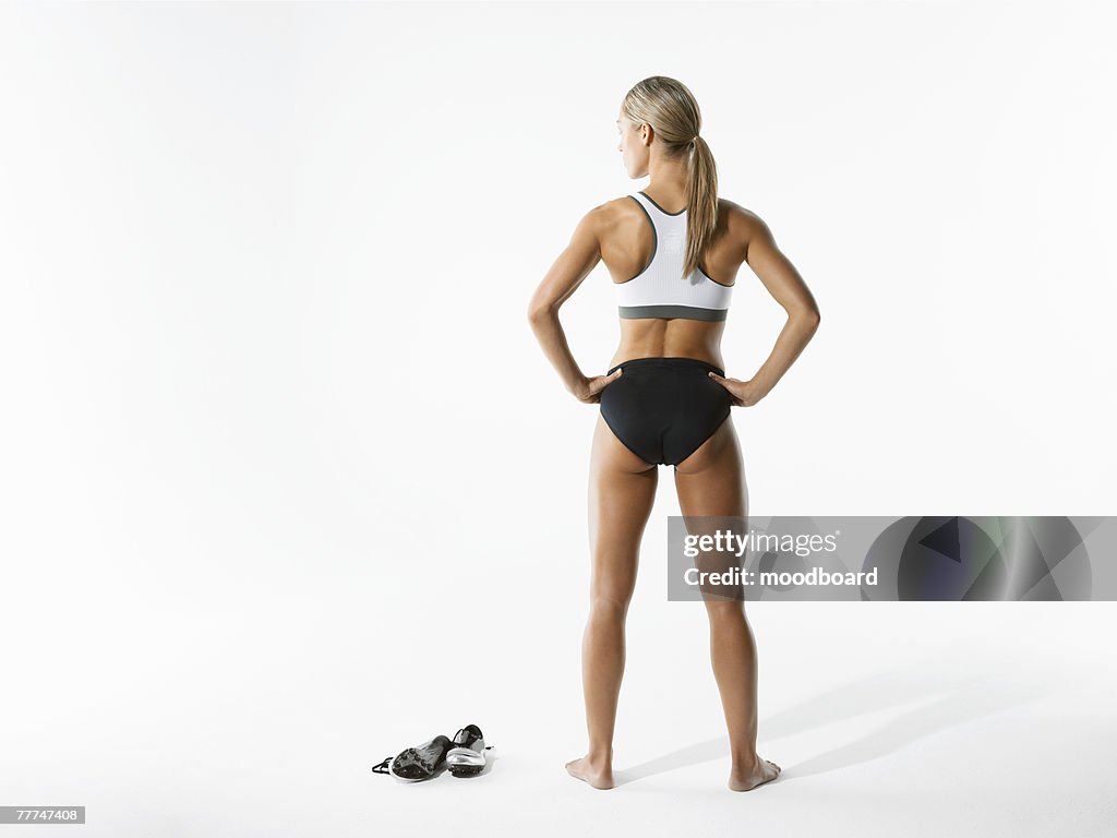 Female Athlete Holding Shoes