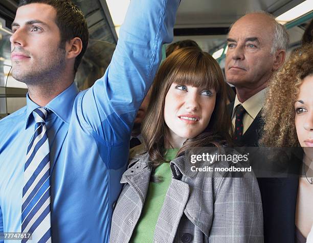 commuter standing by mans wet armpit on train - disgust ストックフォトと画像