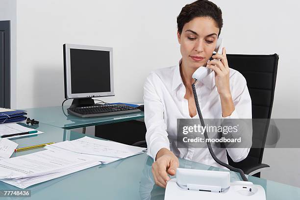 businesswoman dialing telephone - 鳴る ストックフォトと画像