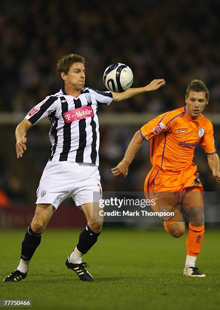 Zoltan Gera of West Bromwich Albion is challenged by Burton O'Brien of Sheffield Wednesday during the Coca-Cola Championship match between West...