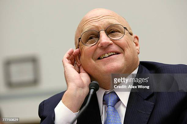 Former Deputy Secretary of State Richard Armitage put his hand next to his ear as he listens to a question during a hearing before the National...