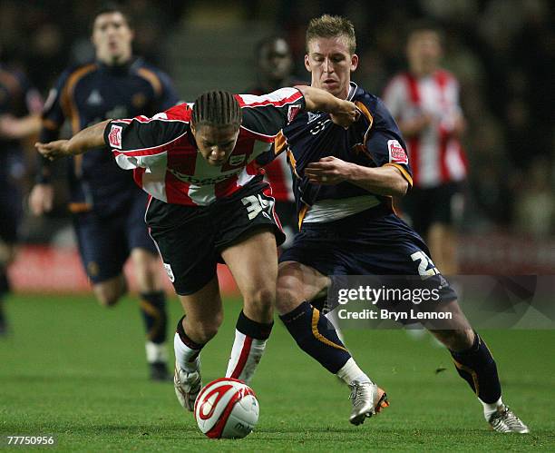Phil Ifil of Southampton is tackled by Freddy Eastwood of Wolverhampton Wanderers during the Coca-Cola Championship match between Southampton and...