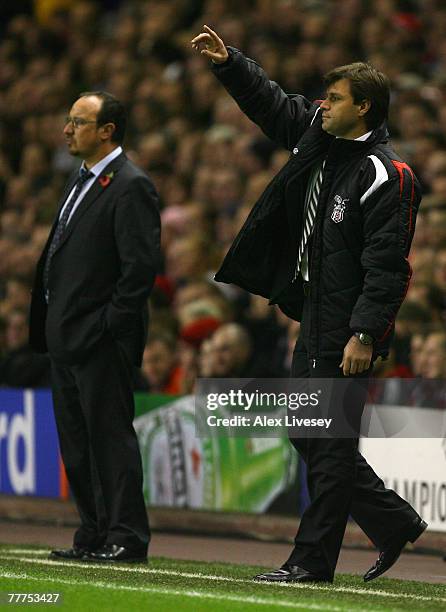 Besiktas Manager Ertugrul Saglam gestures as Liverpool Manager Rafael Benitez looks on during the UEFA Champions League Group A match between...